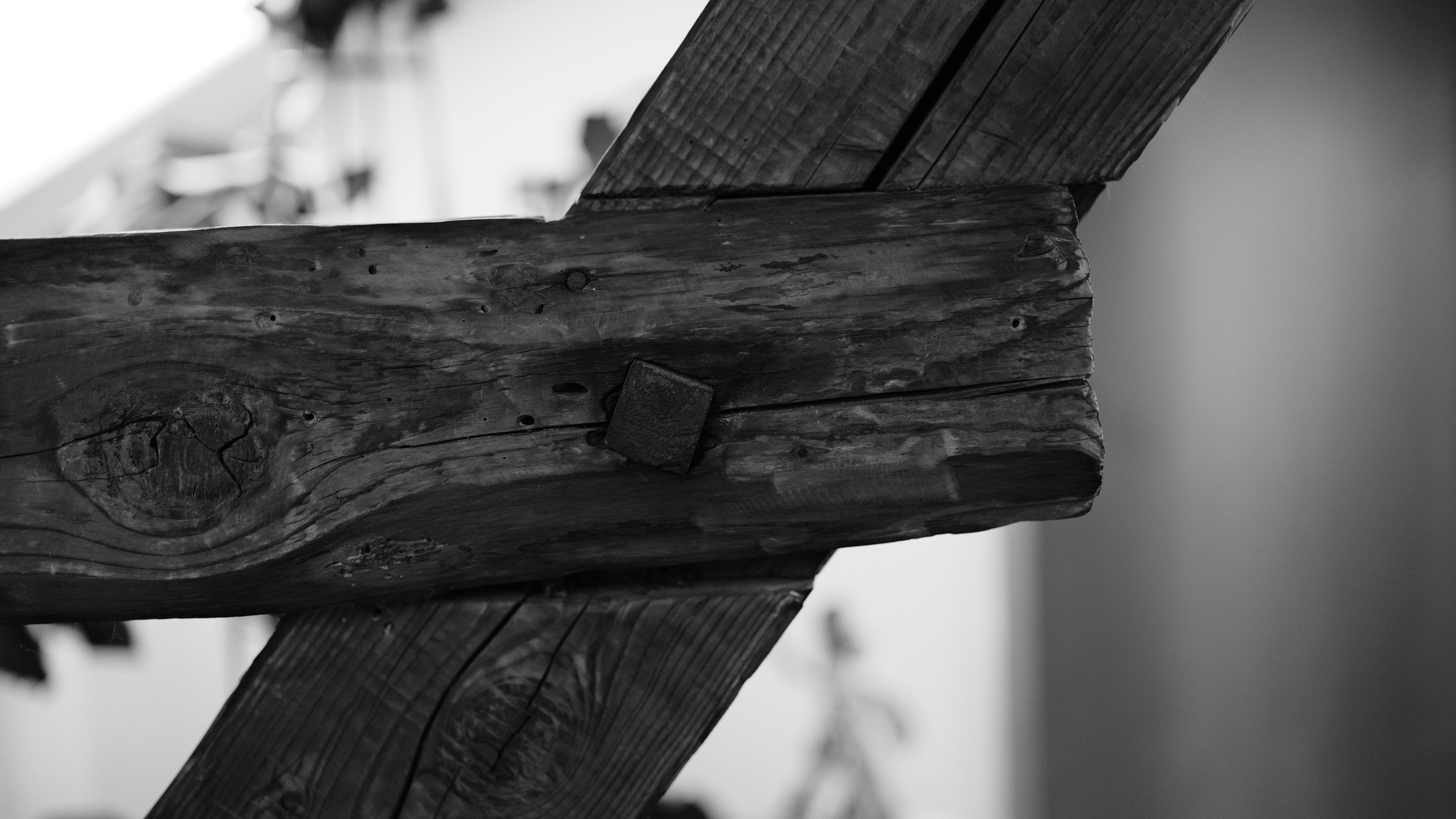 A timber joint held together by a square metal peg.